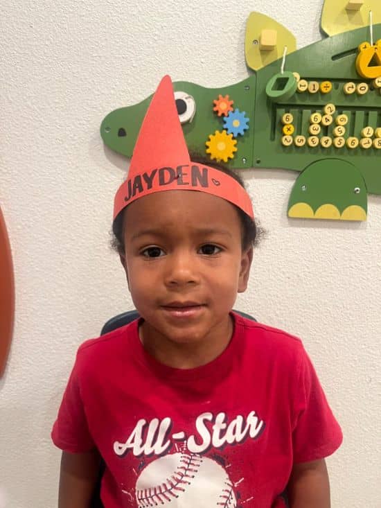 ayden wearing a birthday crown and smiling inside a Christian daycare center classroom in Las Vegas.